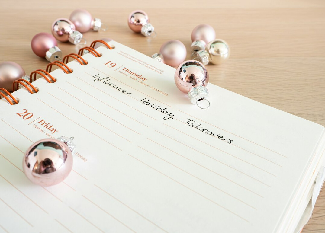 Weekly planner and calendar with a pen on a desk