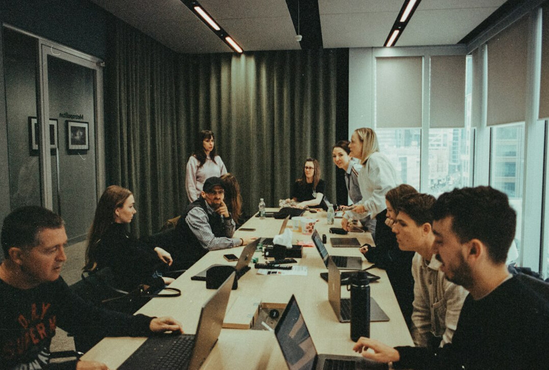 man leading team meeting